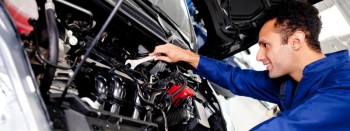 Car mechanic working on car